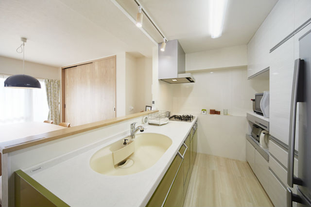 オリーブグリーンの対面キッチンで開放感のあるナチュラルな空間